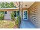 Close up view of the front porch with a secure screen door, and decorative concrete block accent at 2933 Stratford Dr, Largo, FL 33771