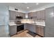 Modern kitchen with stainless steel appliances, sleek gray cabinetry, and stylish tiled backsplash at 2933 Stratford Dr, Largo, FL 33771