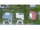 Aerial view of the home showcasing a well-maintained lawn, mature trees, and proximity to neighboring properties at 3300 58Th N St, St Petersburg, FL 33710