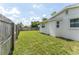 Side view of the yard with grass, fence, and the side of the home at 3300 58Th N St, St Petersburg, FL 33710