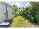 Spacious back yard with grass and a large air conditioner at 3300 58Th N St, St Petersburg, FL 33710