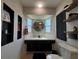 Charming bathroom with a corner vanity, round mirror, natural light, and stylish fixtures for a refreshing experience at 3300 58Th N St, St Petersburg, FL 33710