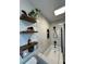Stylish bathroom offering floating wood shelves and a shower over the tub, enhancing the space's overall functionality at 3300 58Th N St, St Petersburg, FL 33710