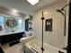 Modern bathroom with a bathtub and shower, vanity with sink, and decorative shelves for a spa-like retreat at 3300 58Th N St, St Petersburg, FL 33710