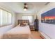 Bedroom with natural light, ceiling fan, and modern decor with a cactus themed picture at 3300 58Th N St, St Petersburg, FL 33710