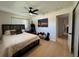 Bedroom featuring wood-look floors, ceiling fan, and a window offering natural light, providing a comfortable setting at 3300 58Th N St, St Petersburg, FL 33710