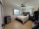 Comfortable bedroom featuring a window, wood-look floors, ceiling fan, and cozy bed, offering a relaxing ambiance at 3300 58Th N St, St Petersburg, FL 33710