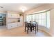 Bright dining area with light wood floors, a modern chandelier, and lots of natural light at 3300 58Th N St, St Petersburg, FL 33710