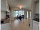 Open concept dining and kitchen area with new cabinets, stainless steel appliances, and modern lighting at 3300 58Th N St, St Petersburg, FL 33710