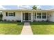 Inviting front entrance features a well-maintained lawn and a walkway leading to the front door at 3300 58Th N St, St Petersburg, FL 33710