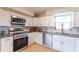 Updated kitchen boasts stainless steel appliances, granite countertops, and ample cabinet space at 3300 58Th N St, St Petersburg, FL 33710