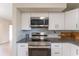Updated kitchen features modern stainless steel appliances and granite countertops at 3300 58Th N St, St Petersburg, FL 33710