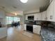 Open kitchen with stainless steel appliances, stone countertops, and direct access to the dining area at 3300 58Th N St, St Petersburg, FL 33710