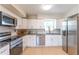 Bright kitchen with stainless steel appliances, white cabinets, and granite countertops at 3300 58Th N St, St Petersburg, FL 33710