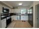 Modern kitchen with stainless steel appliances, white cabinets, and stylish countertops at 3300 58Th N St, St Petersburg, FL 33710