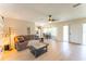 Bright living room features wood floors, couch, dinette in the bay window, and a sliding barn door at 3300 58Th N St, St Petersburg, FL 33710