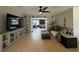 Bright living room with light floors, ceiling fan, and sliding barn door to bonus room at 3300 58Th N St, St Petersburg, FL 33710