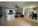 Bright, open-concept living room with hardwood floors, modern ceiling fan, and sliding barn doors at 3300 58Th N St, St Petersburg, FL 33710