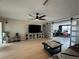 Bright living room with light floors, ceiling fan, and sliding barn door to bonus room at 3300 58Th N St, St Petersburg, FL 33710