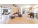 Open-concept interior with light wood flooring, comfortable seating, and a view into the kitchen and living spaces at 3300 58Th N St, St Petersburg, FL 33710