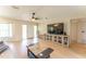 Living area with wood floors and a large media center and a view of the front door at 3300 58Th N St, St Petersburg, FL 33710