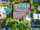 Aerial view of a beautiful home with a screened-in pool, lush landscaping, and a well-manicured lawn at 3304 Latania Dr, Tampa, FL 33618