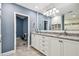 Bright bathroom featuring granite countertops, large mirror, and access to the tiled shower room at 3304 Latania Dr, Tampa, FL 33618