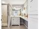Updated bathroom boasts a glass shower, vanity and makeup area with ample lighting at 3304 Latania Dr, Tampa, FL 33618