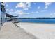 Scenic lake view from the covered pier with white sand beach and calm waters, perfect for recreation at 3304 Latania Dr, Tampa, FL 33618