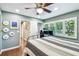 This serene bedroom features white shuttered windows, and a ceiling fan at 3304 Latania Dr, Tampa, FL 33618