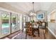Elegant dining room with modern chandelier and views of the outdoor pool area at 3304 Latania Dr, Tampa, FL 33618