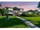 Beautiful two-story home with manicured lawn, lovely landscaping, and a charming walkway leading to the front door at 3304 Latania Dr, Tampa, FL 33618