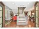 Elegant foyer featuring hardwood floors, a staircase, a stylish table, and a decorative mirror at 3304 Latania Dr, Tampa, FL 33618