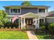 Beautiful home with lush landscaping, mature trees, a well manicured lawn, and traditional architectural details at 3304 Latania Dr, Tampa, FL 33618