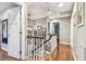 Open hallway with lots of natural light, hardwood floors, and a stairwell at 3304 Latania Dr, Tampa, FL 33618