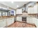 Charming kitchen with stainless steel appliances, brick backsplash, and granite countertops at 3304 Latania Dr, Tampa, FL 33618