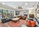 Spacious living room with stylish furniture, large windows, and hardwood floors at 3304 Latania Dr, Tampa, FL 33618