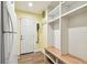 Functional mud room includes a bench with cubbies, coat racks, and easy access to the outside at 3304 Latania Dr, Tampa, FL 33618