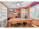 Functional home office with a large desk, ample shelving, natural light, and a ceiling fan at 3304 Latania Dr, Tampa, FL 33618