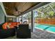 Inviting covered patio featuring brick pavers, ceiling fans, comfortable seating, and a sparkling screened-in pool at 3304 Latania Dr, Tampa, FL 33618