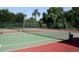 Well-maintained tennis courts surrounded by mature trees offer a private recreational amenity for residents at 3304 Latania Dr, Tampa, FL 33618