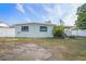 View of the home's backyard, showing the exterior with a covered patio at 3308 W Walnut St, Tampa, FL 33607