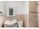 Updated bathroom featuring tile walls, a shower, a toilet, and a vanity sink with mirror at 3308 W Walnut St, Tampa, FL 33607
