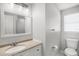 Clean bathroom featuring a large mirror, a white vanity, and a toilet at 3308 W Walnut St, Tampa, FL 33607