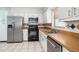 Well-lit kitchen with white cabinets, stainless steel appliances, and tiled floors at 3308 W Walnut St, Tampa, FL 33607