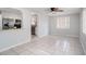 Bright living room featuring tile flooring, a ceiling fan, and an open view of the kitchen at 3308 W Walnut St, Tampa, FL 33607