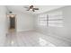 Bright living room featuring tile flooring, a ceiling fan and a large window at 3308 W Walnut St, Tampa, FL 33607