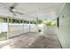 Covered patio features lattice privacy screening and dual ceiling fans overlooking backyard at 3308 W Walnut St, Tampa, FL 33607