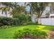 Lush backyard with manicured landscaping, privacy fence, and mature trees at 3619 W Leona St, Tampa, FL 33629