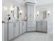 Elegant bathroom featuring double vanities and marble countertops at 3619 W Leona St, Tampa, FL 33629